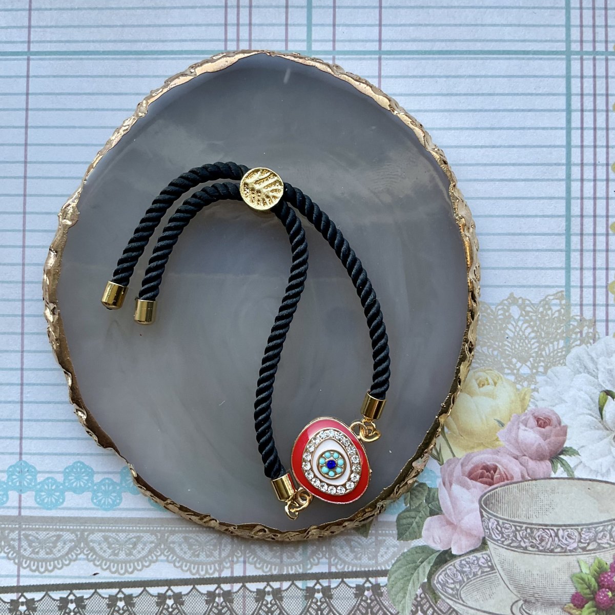 Adjustable cord bracelet with enamel charm. - Image 2