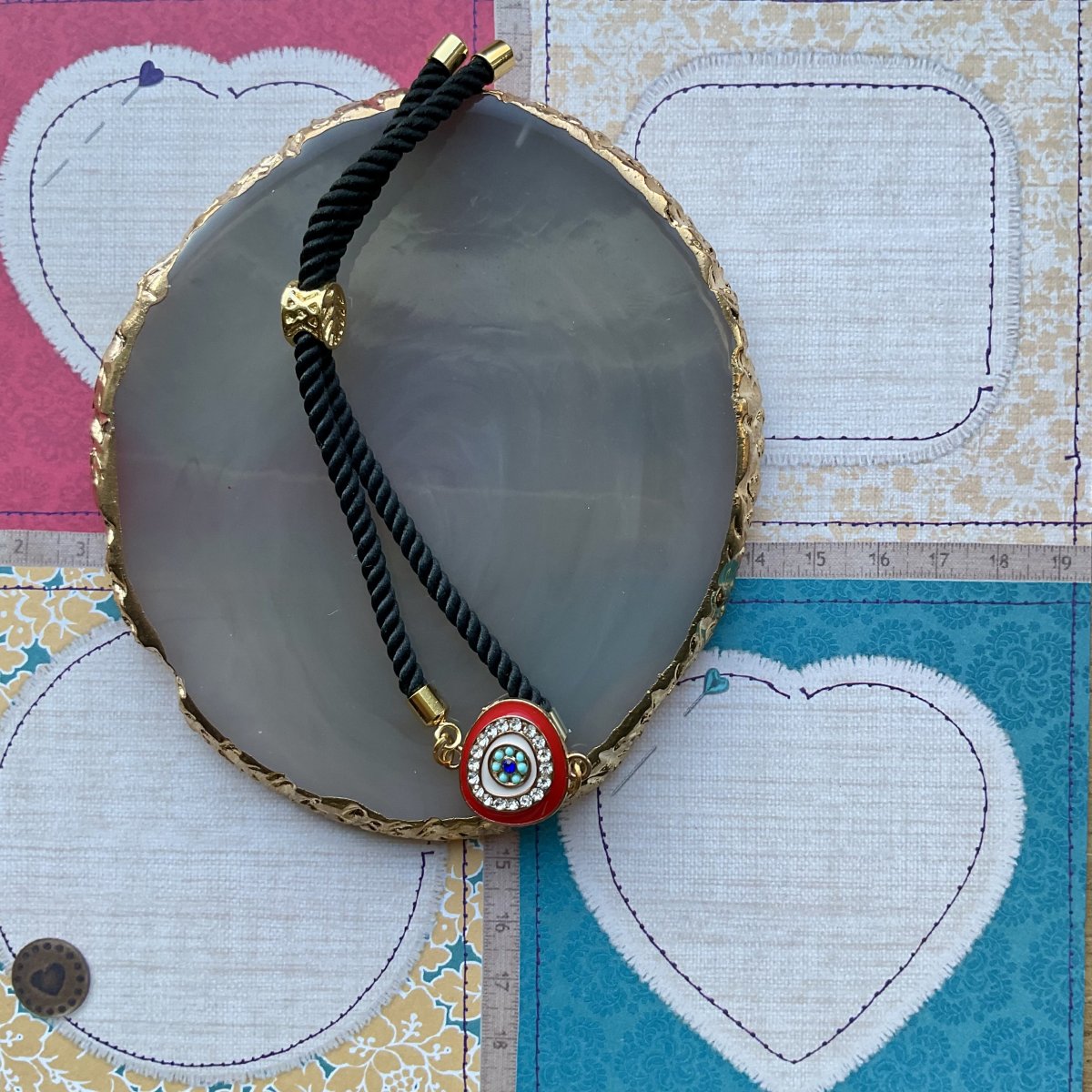 Adjustable cord bracelet with enamel charm. - Image 3